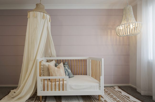 Carolina 1 311 nursery with pink panelled wall and chandelier