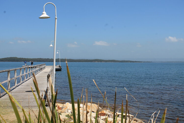 people fishing on the jetty at murrays beach